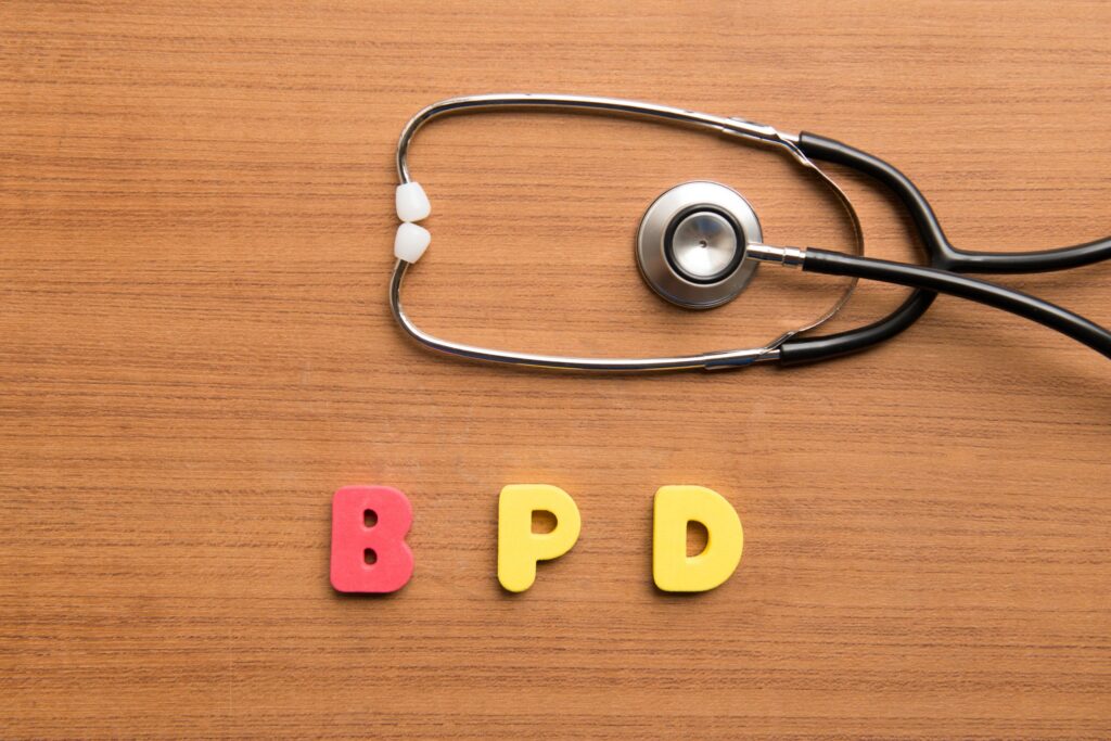 letters spelling out BPD and a doctors stethoscope laying on the table
