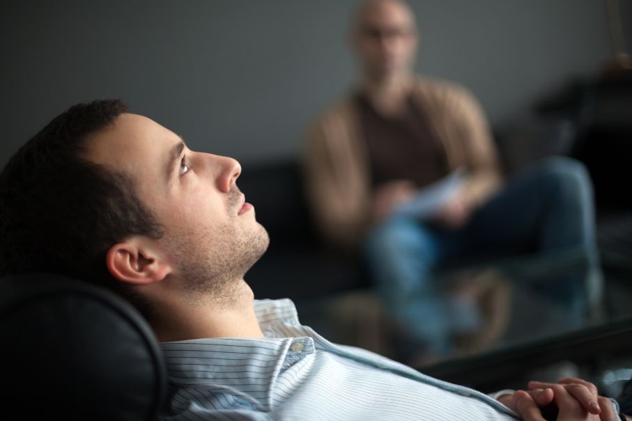 Man sitting on couch at valor behavioral health talking to his therapist about struggling with OCD in atlanta georgia