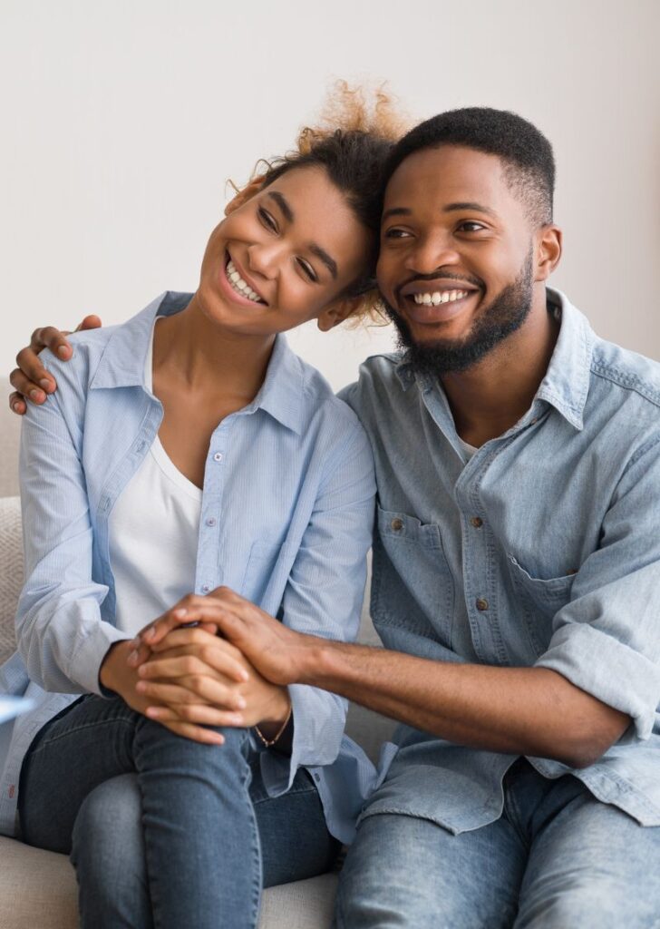 couple sitting happy in therapy dealing with Living with A Spouse with Mental Illness