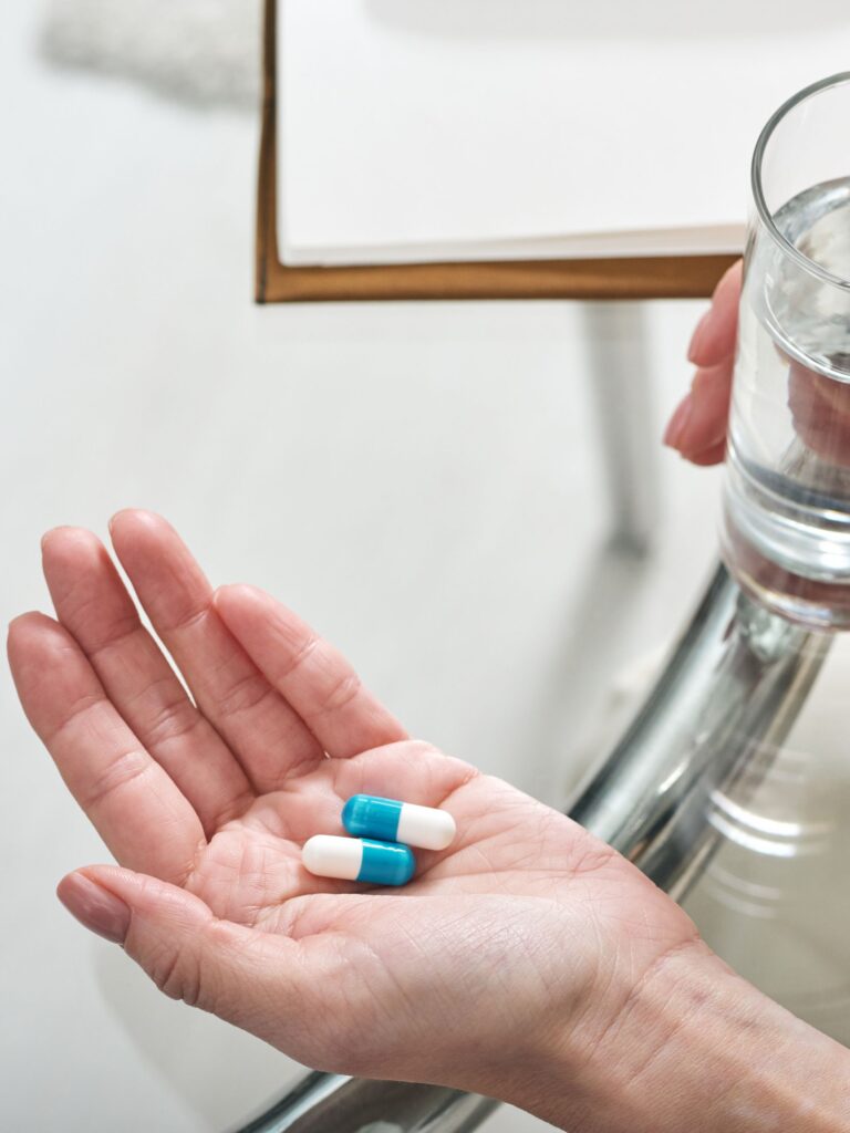 person holding their medication for mental illness pros and cons