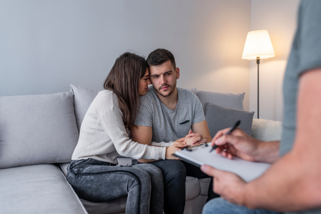 couple sitting in therapy asking can men get postpartum depression